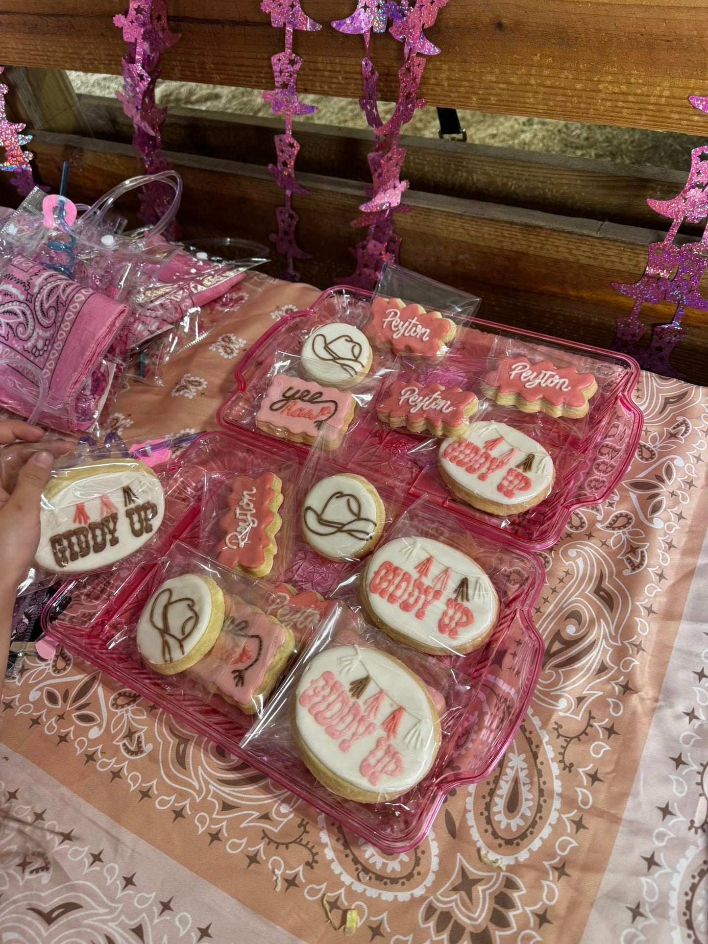 Kids seated at a decorated party table during a birthday celebration inside the Rodeo Stables barn.