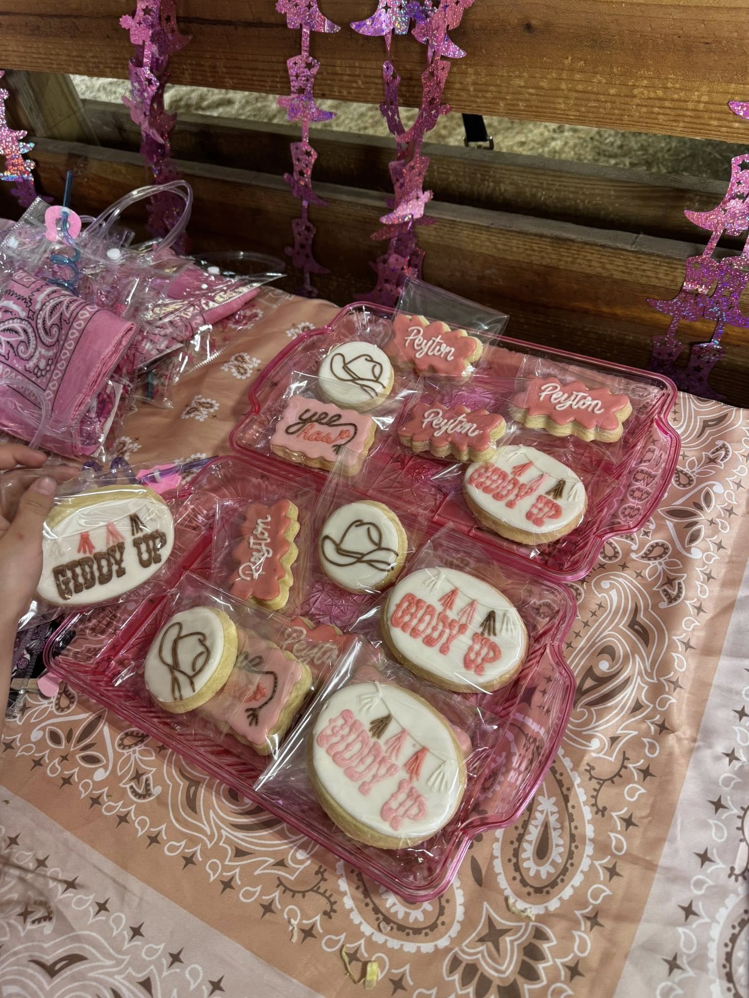 Kids seated at a decorated party table during a birthday celebration inside the Rodeo Stables barn.