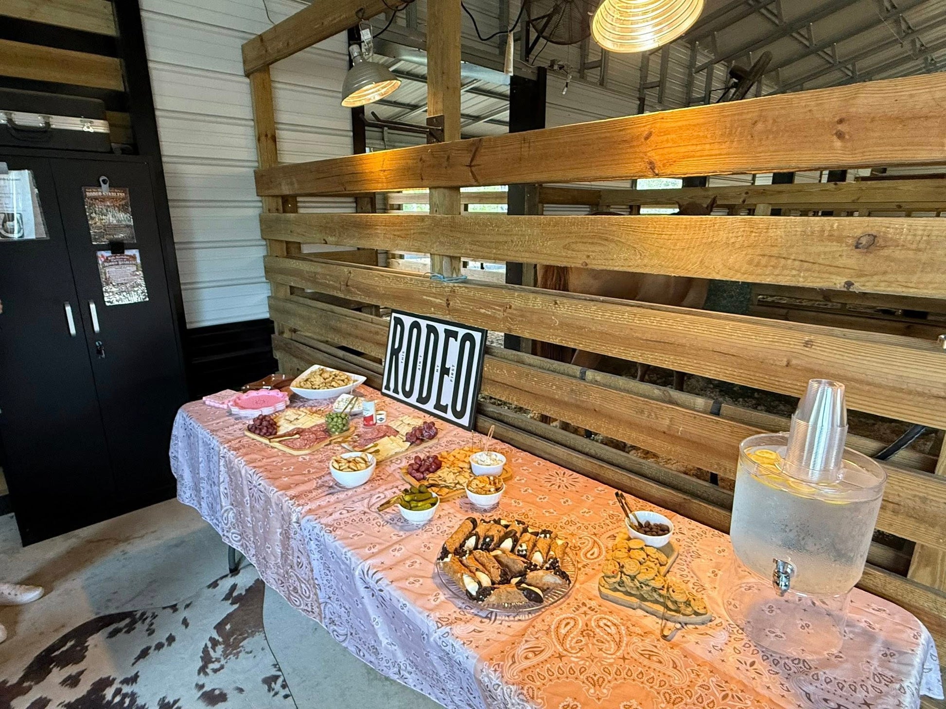 Charcuterie and refreshment table setup inside Rodeo Stables for a private barn event in Ormond Beach, Florida.