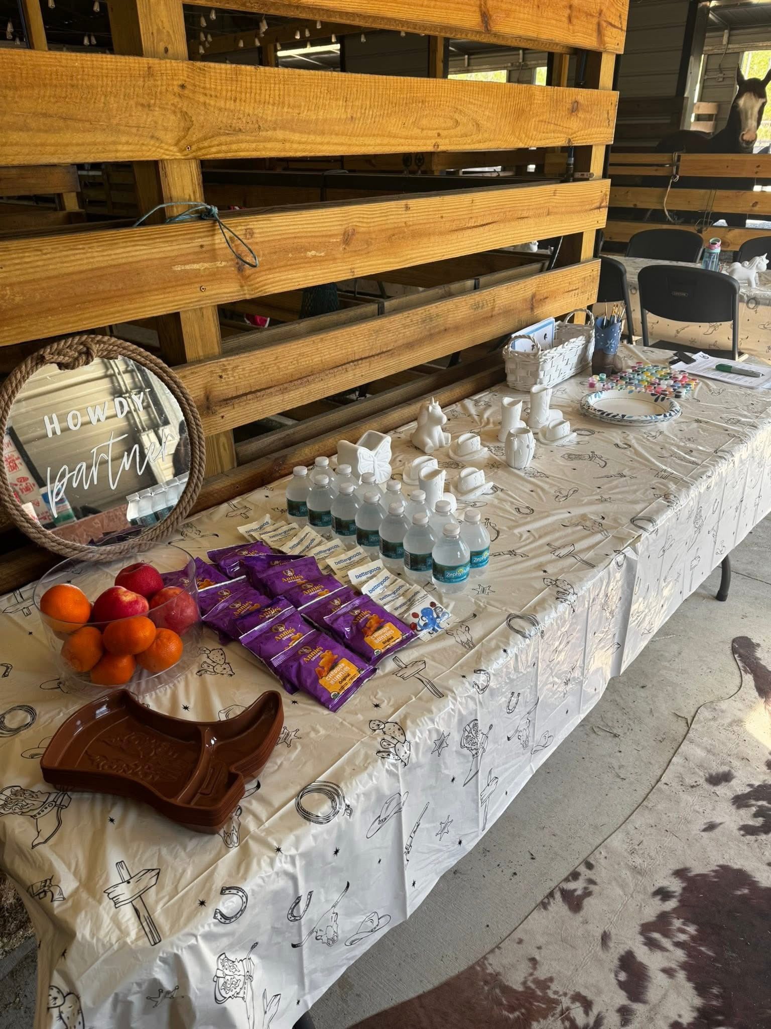 Horse-themed birthday party food and decorations inside the barn at Rodeo Stables.