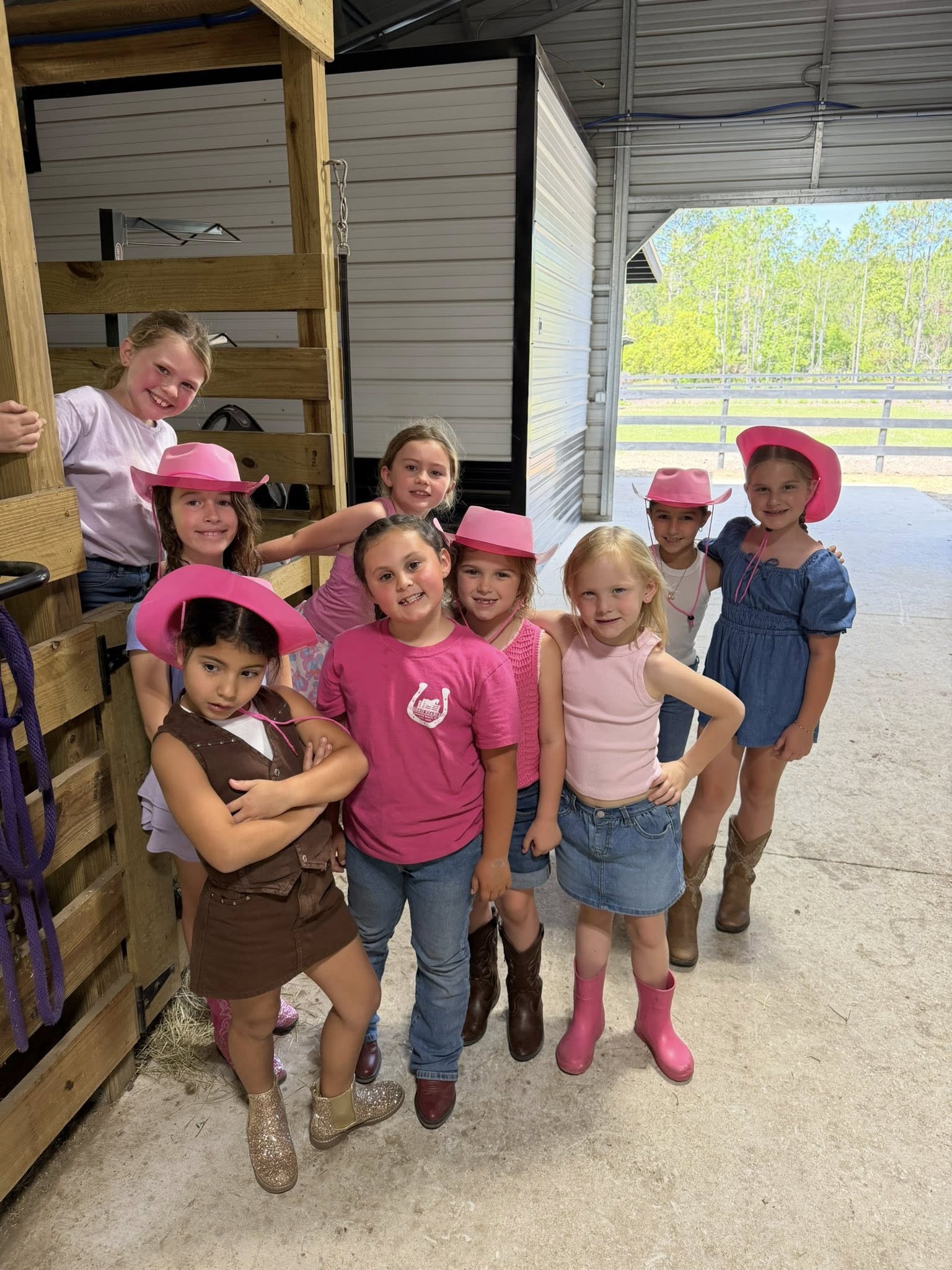 Children standing with a mini horse during an outdoor kids activity at Rodeo Stables in Ormond Beach, Florida.