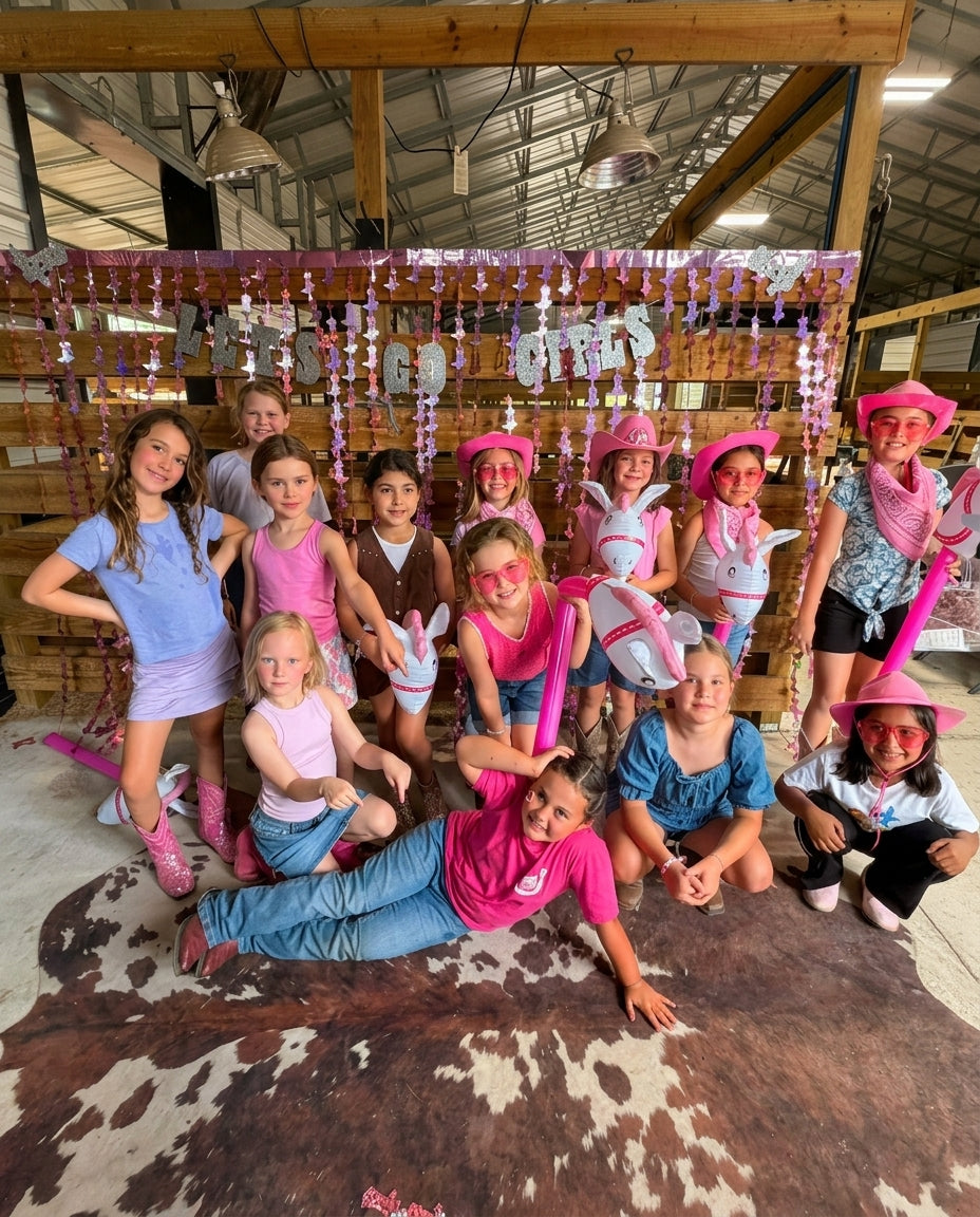 Kids dressed in pink western outfits during a cowgirl-themed birthday party at Rodeo Stables in Ormond Beach, Florida.