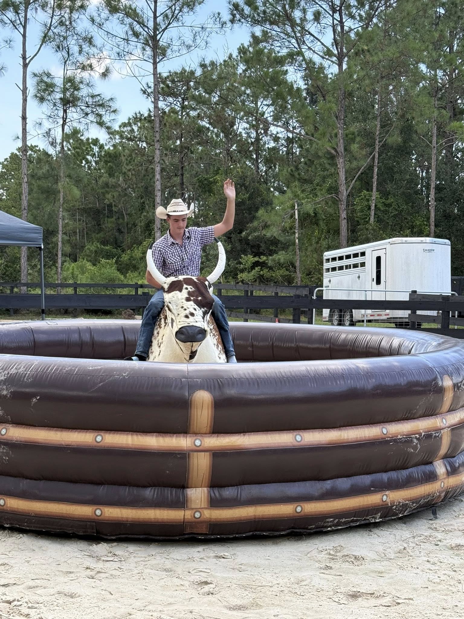 Guest riding a mechanical bull during a western-themed event at Rodeo Stables in Ormond Beach, Florida