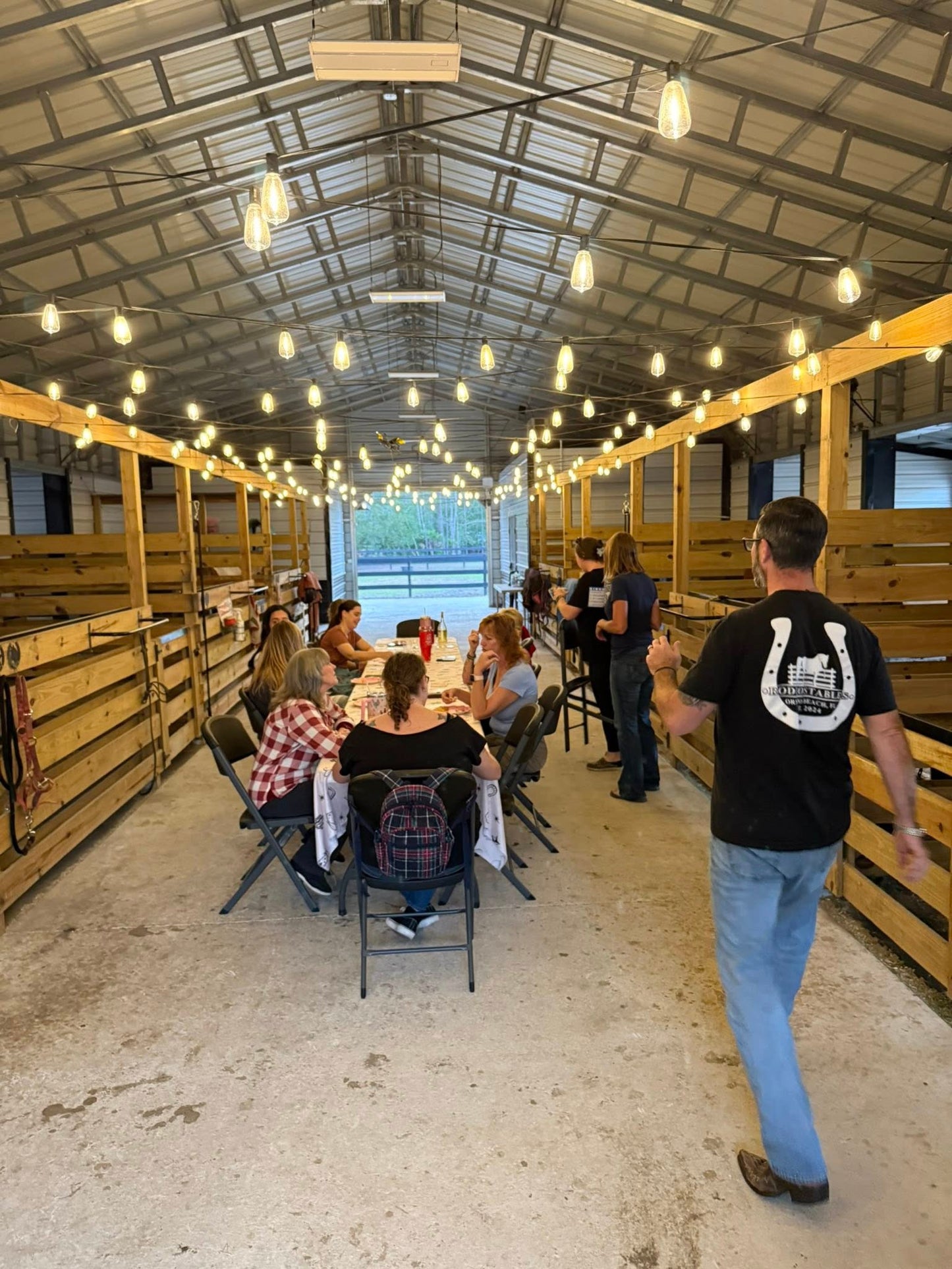 Guests smiling during Bingo Night inside the Rodeo Stables barn event space in Ormond Beach, Florida.