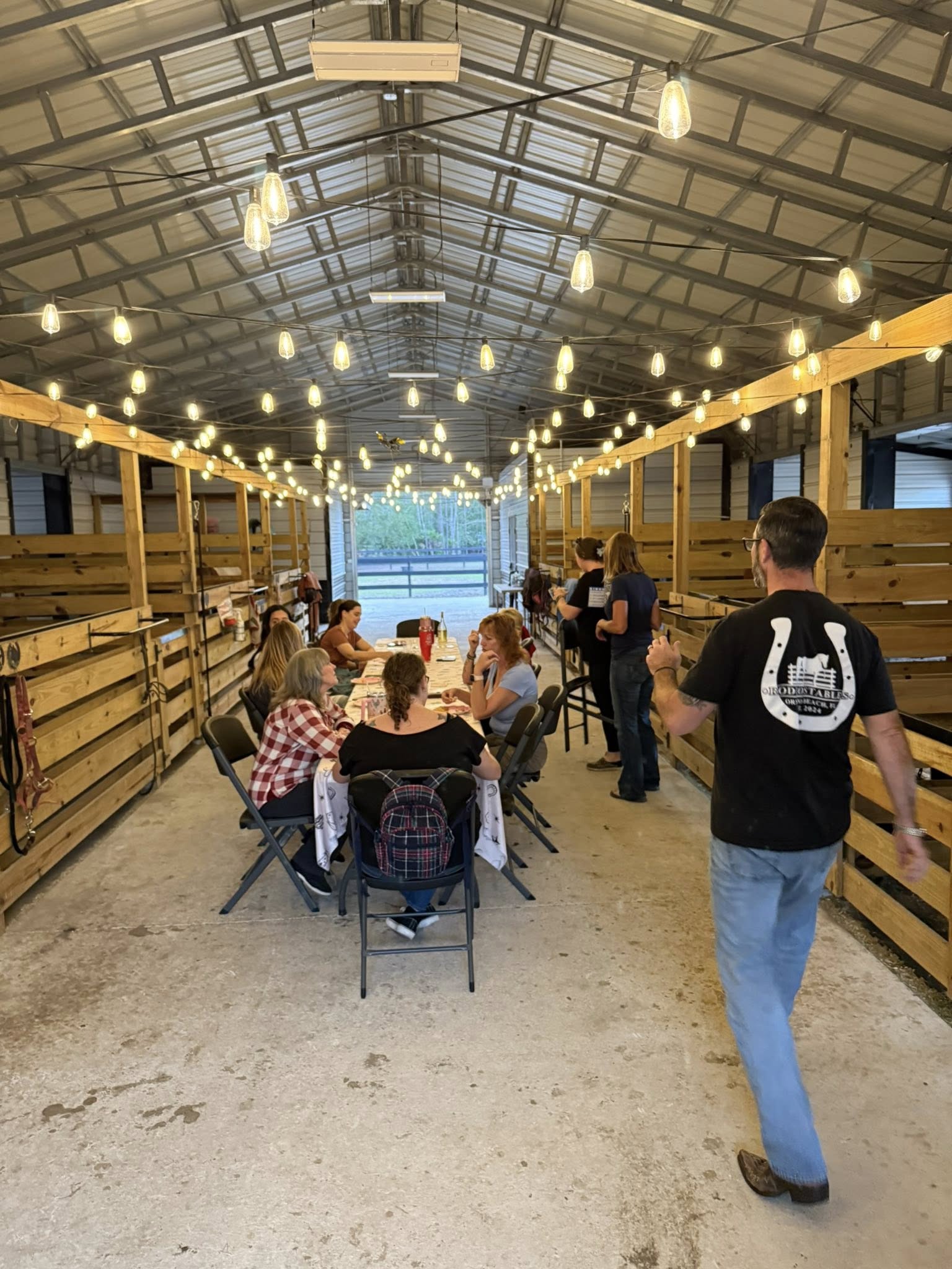 Guests smiling during Bingo Night inside the Rodeo Stables barn event space in Ormond Beach, Florida.