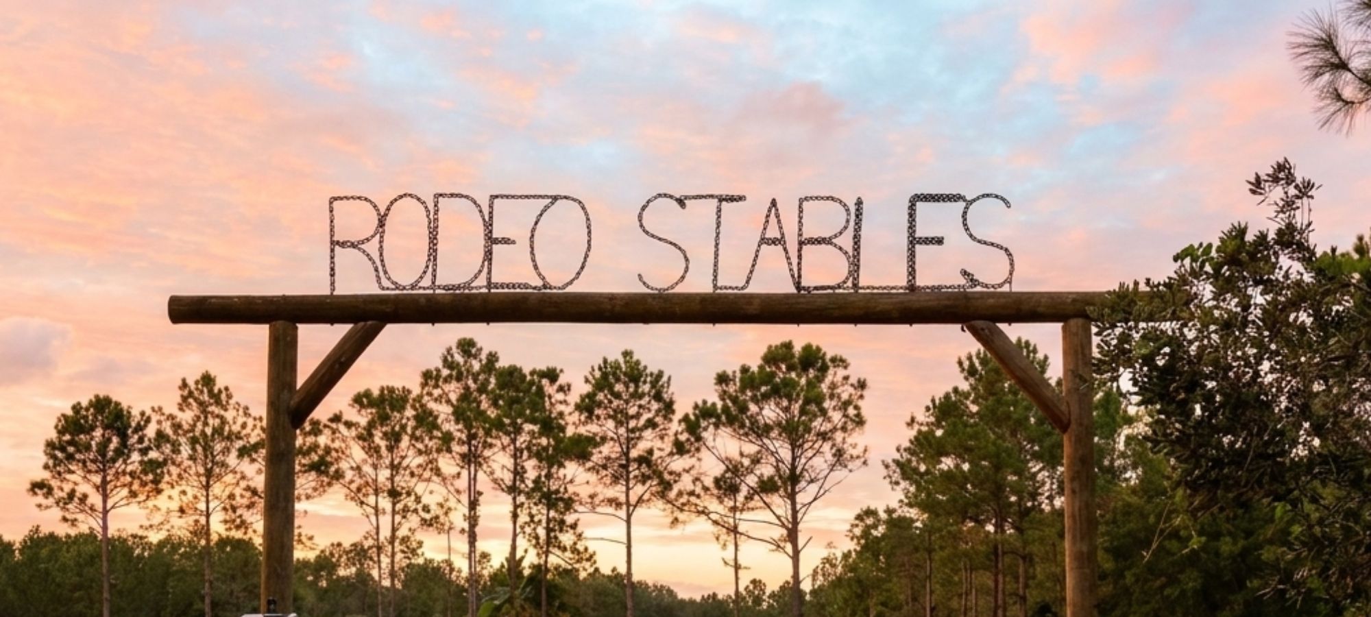 Entrance to Rodeo Stables horse property at sunset
