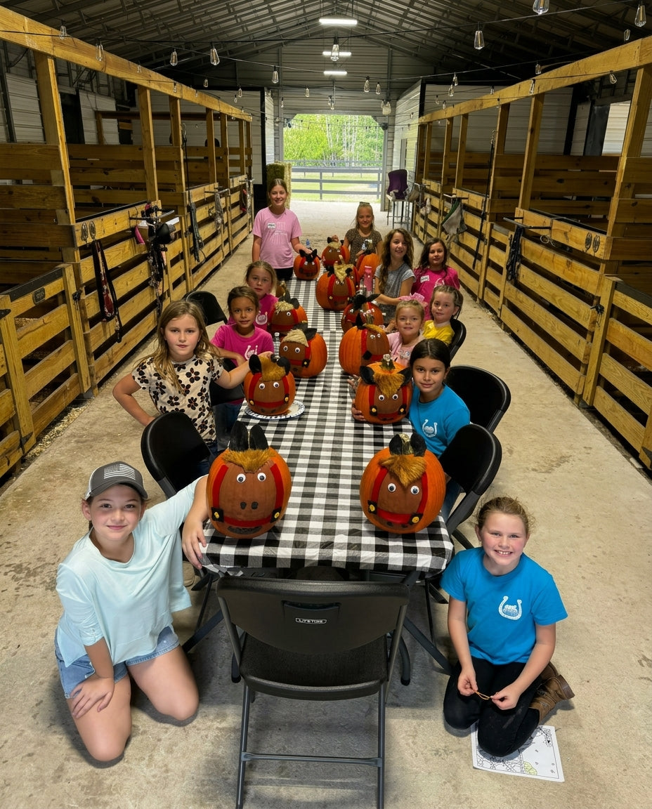 Kids participating in a seasonal pumpkin craft activity inside the Rodeo Stables barn in Ormond Beach, Florida.
